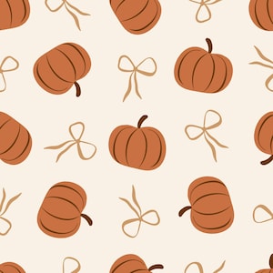May include: A repeating pattern featuring brown pumpkins and tan bows on a cream background. The pumpkins have vertical lines and dark brown stems. The bows are simple and elegant, creating a fall or harvest theme.