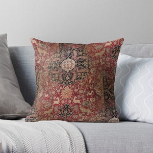 May include: A throw pillow featuring a vintage Persian rug design with intricate patterns and a central medallion. The rug is predominantly red with accents of gold, black, and blue.