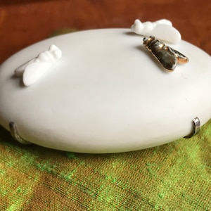 May include: White ceramic oval dish with three small decorative butterflies. Two butterflies are white and one is gold and black.