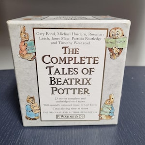 May include: A white box set titled The Complete Tales of Beatrix Potter containing 6 audio tapes. The front features illustrations of Benjamin Bunny, Squirrel Nutkin, Tom Kitten, and Peter Rabbit, with text listing the narrators and F. Warne & Co.