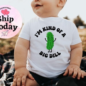 May include: White baby onesie with a green cartoon pickle and the text "I'm kind of a big dill".