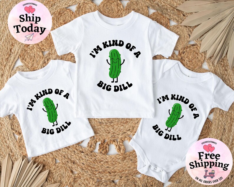 May include: Three white t-shirts with a green pickle graphic and the text "I'm kind of a big dill".