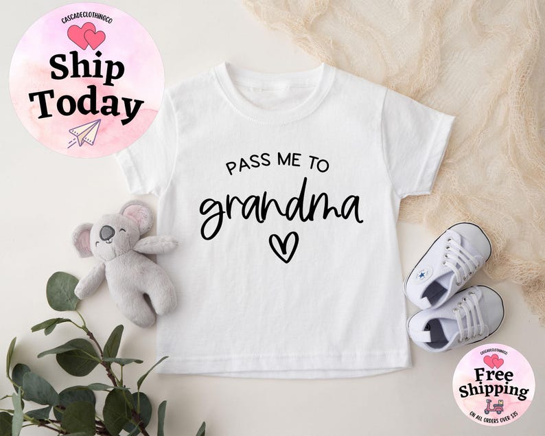 May include: White baby onesie with black text that reads "Pass me to grandma" with a small heart symbol.