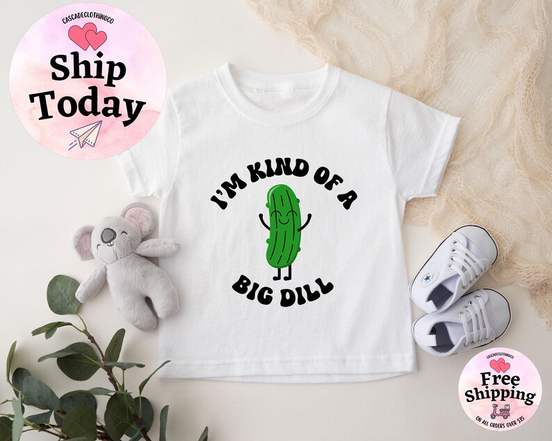 May include: White baby onesie with a green pickle cartoon character and the text "I'm kind of a big dill".