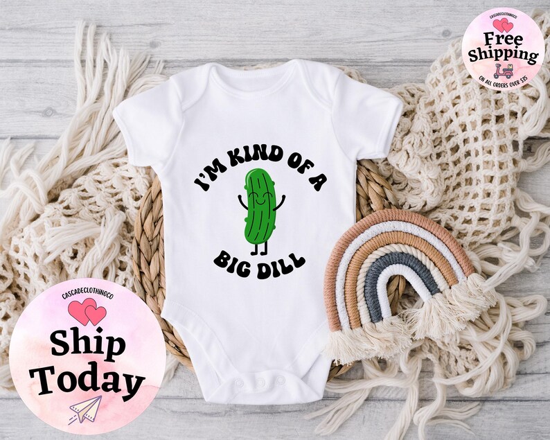 May include: White baby onesie with a green cartoon pickle and the text "I'm kind of a big dill".
