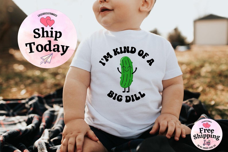 May include: White baby onesie with a green cartoon pickle and the text "I'm kind of a big dill".