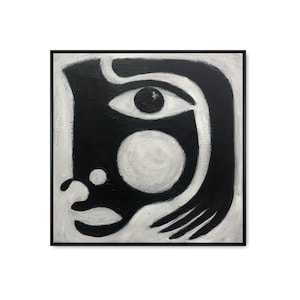 黒と白の抽象的な目の顔の絵画