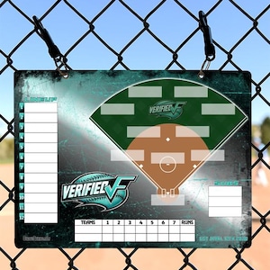 May include: A baseball lineup and score board with a teal and green design. The board features a baseball field diagram, team lineup slots, and spaces for runs. The "VERIFIED" logo is prominently displayed. The board is hanging on a chain-link fence.