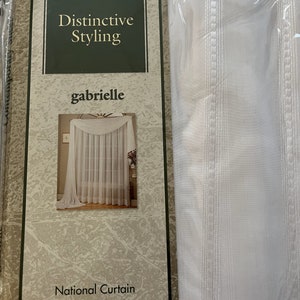 May include: White sheer curtains with a striped pattern, packaged with a label that reads "Distinctive Styling" and "gabrielle" with a picture of the curtains hanging in a window. The label also reads "National Curtain".