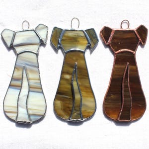 May include: Three stained glass dog ornaments, one white, one brown, and one gold.