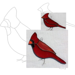 May include: A stained glass cardinal with red and black accents. The cardinal is hanging from a wire loop.