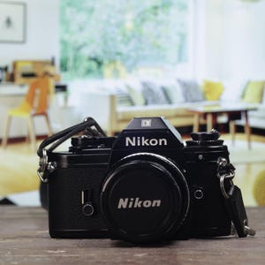 Nikon EM slr 35mm film camera w/Nikon 50mm f1.8mm prime pancake lens