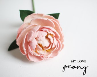 May include: A handmade, light pink felt peony flower with a green stem and leaves. The flower has multiple layers of petals and a yellow center. Text on the image reads "MY LOVE peony".