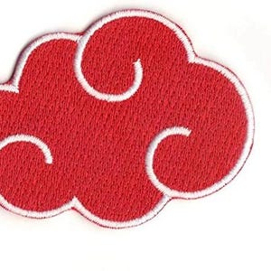 May include: Red embroidered iron-on patch with a white outline in the shape of a cloud with swirls.
