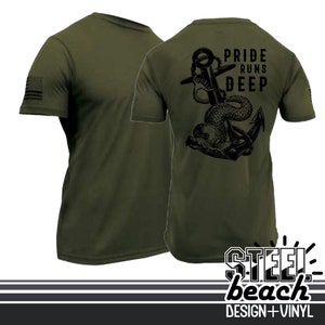 May include: Olive green t-shirt with a black graphic of an anchor and a sea serpent, with the text "PRIDE RUNS DEEP" on the back. The American flag is printed on the left sleeve. The shirt is from Steel Beach Design + Vinyl.