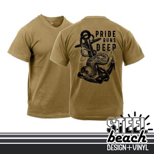 May include: Two tan t-shirts. The back of one shirt features a black graphic of an anchor intertwined with a serpent, and the text "PRIDE RUNS DEEP". The bottom right corner of the image has the text "STEEL beach DESIGN + VINYL".