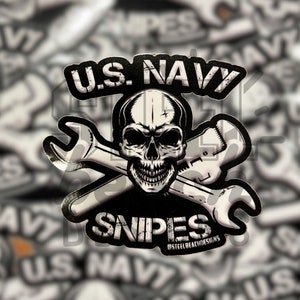 May include: Black and white sticker with a skull and crossbones design. The skull has a menacing expression and the crossbones are wrenches. The text "U.S. NAVY SNIPES" is printed on the sticker.