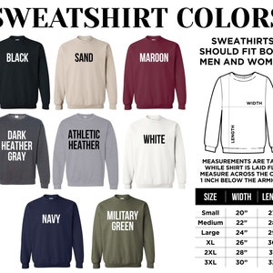 May include: A graphic showing sweatshirt colors in black, sand, maroon, dark heather gray, athletic heather, white, navy, and military green. The image includes a diagram with measurements and a size chart with width and length in inches.