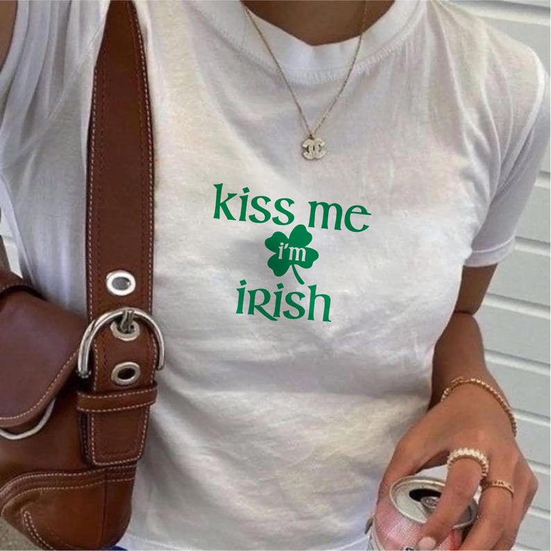 May include: White t-shirt with green shamrock and the text "kiss me i'm irish"