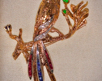 Vintage Cherny 18k yellow and white gold bird pin with diamonds, rubies and blue sapphires and an emerald