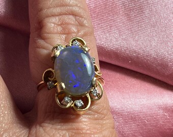 Vintage 18K yellow gold ring with a mesmerizing black opal framed with sparkling diamonds