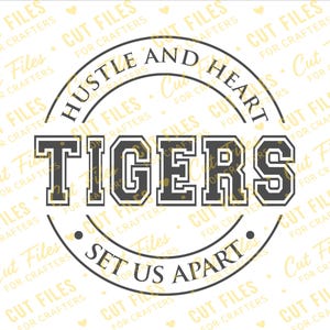 May include: A circular graphic design featuring the text HUSTLE AND HEART in an arc at the top and SET US APART at the bottom. The word TIGERS is displayed in large, bold, block-style lettering across the center. The design uses dark outlines.