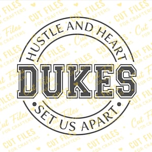 May include: A circular graphic design featuring the text DUKES in large, bold, dark gray block letters at the center. The words HUSTLE AND HEART are arched along the top, and SET US APART is arched along the bottom, all enclosed in a thin circle.