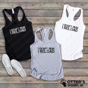 May include: Three tank tops with the text "I don't run I reload" in black lettering. The tank tops are black, grey, and white.