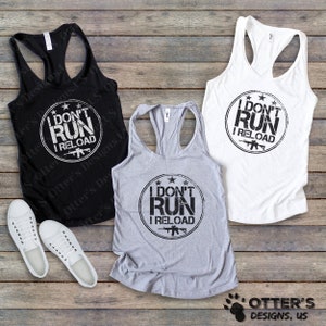 May include: Three tank tops with a distressed black graphic that reads "I don't run I reload" with a star and a rifle graphic. The tank tops are in black, white, and heather grey.
