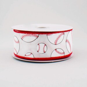 May include: A roll of white baseball-themed ribbon. The ribbon features a repeating pattern of baseballs with red stitching and black outlines. The edges are trimmed with red stitching. The ribbon is on a white spool.
