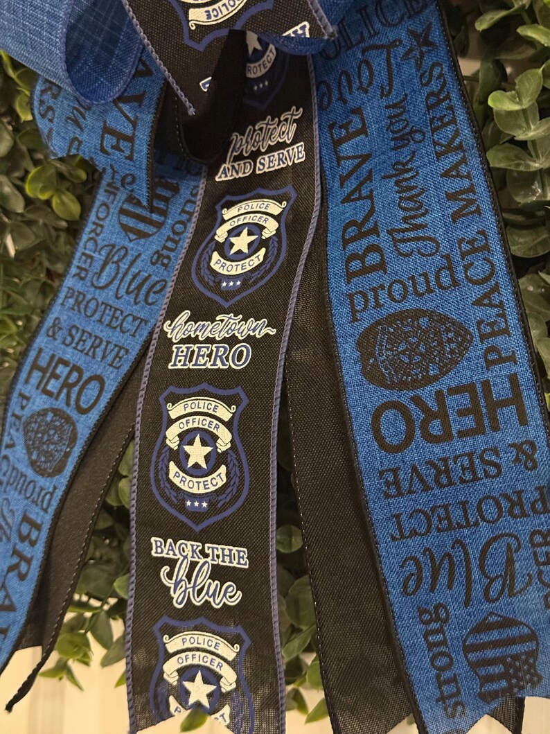 May include: Blue and black ribbon with the text "Protect and Serve", "Hometown Hero", "Back the Blue", "Brave", "Thank you", "Peace Makers", "Strong", "Protect and Serve", "Blue", "Hero" and a police officer badge.