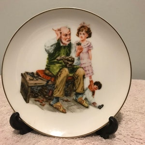 Vintage 1980s hand painted Norman Rockwell inspired decorative plates “ The Cobbler ” home decor kitchen decor