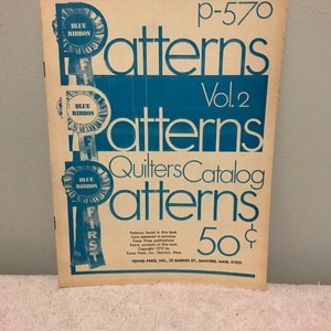 May include: A vintage blue and white book titled "Patterns Quilters Catalog" with a blue ribbon on the cover. The book is titled "Patterns Vol. 2" and costs 50 cents. The book was published by Tower Press, Inc. in 1970.
