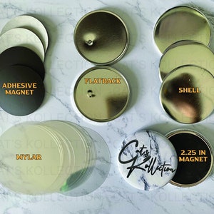 May include: A collection of button-making supplies, including adhesive magnets, flatbacks, shells, mylar covers, and a finished button with a marble design. The text on the button reads "Cat's Kollection" and "2.25 IN MAGNET".