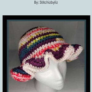 May include: A colorful crocheted bucket hat with a ruffled brim. The hat is made with a variety of colors, including pink, red, purple, blue, and green.