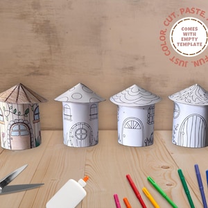 May include: Four printable paper houses with different designs, ready to be colored, cut, and pasted. The houses are arranged in a row on a wooden surface. The image also includes scissors, glue, and colored markers.