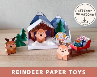 May include: A Christmas-themed paper craft set with reindeer, a snowman, and a sleigh laden with presents. The scene includes a mountain backdrop, trees, and a cabin. The words "Instant Download" are in a circle.