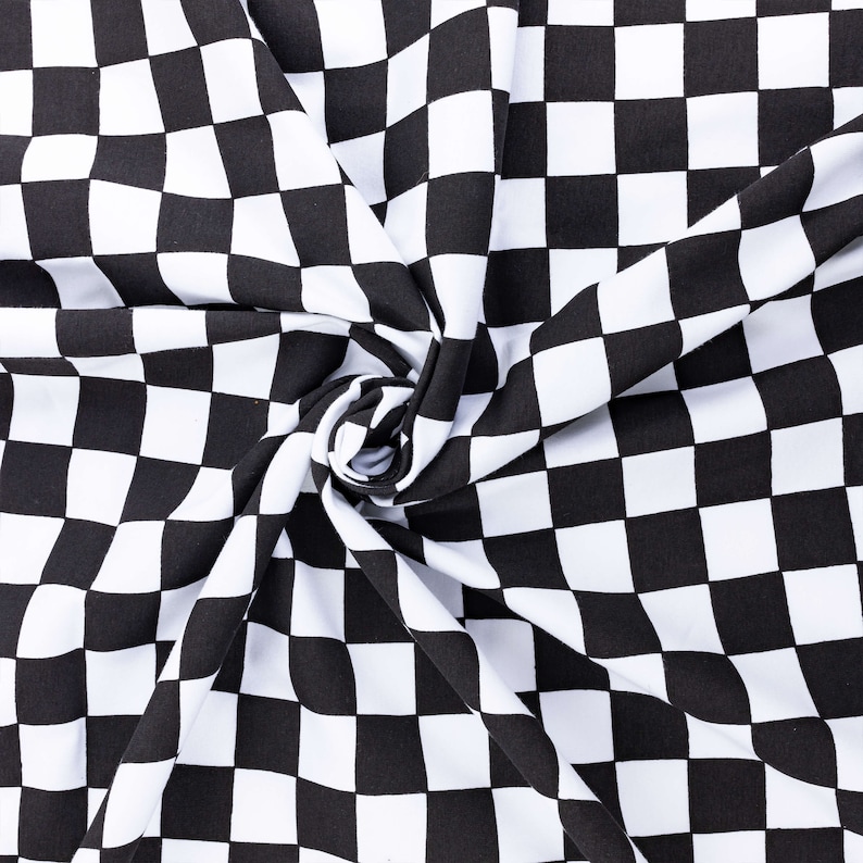 May include: Black and white checkered fabric with a swirling pattern. The fabric is made of a soft, smooth material and has a subtle sheen.