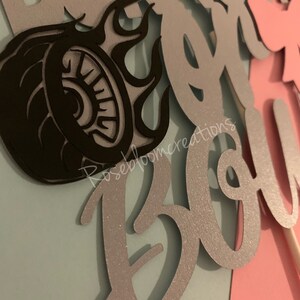May include: Silver glitter cake topper with the words "Burnout is a B*tch" and a black silhouette of a tire with flames.