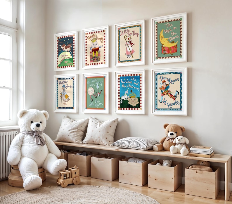 May include: A collection of framed nursery rhyme illustrations, including "Mother Goose" and "The Man in the Moon," adorn a white wall. A large white teddy bear sits near a wooden bench with storage boxes. The room is decorated with soft toys and pillows.