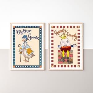May include: Two framed nursery art prints featuring classic nursery rhyme characters. One print shows Mother Goose with a cane, wearing a hat and cape. The other print depicts Humpty Dumpty wearing a crown, sitting on a brick wall.