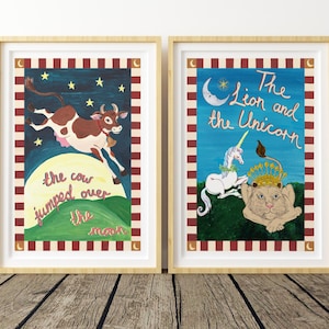 May include: Two framed art prints. One depicts a brown and white cow jumping over a green hill with the text "the cow jumped over the moon." The other shows a lion and unicorn with the text "The Lion and the Unicorn."