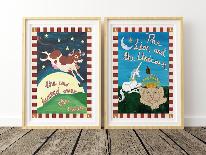 May include: Two framed art prints. One depicts a brown and white cow jumping over a green hill with the text "the cow jumped over the moon." The other shows a lion and unicorn with the text "The Lion and the Unicorn."