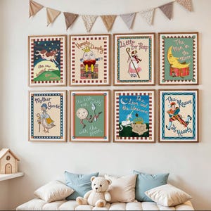 May include: Nine framed nursery rhyme prints, including "The Cow Jumped Over the Moon" and "Humpty Dumpty," are displayed on a white wall. The prints have colorful illustrations and text, with a wooden frame. A cozy reading nook is in the foreground.