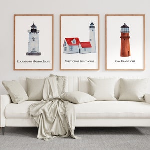May include: Three watercolor paintings of lighthouses in wooden frames. The first painting is of Edgartown Harbor Light, the second is of West Chop Lighthouse, and the third is of Gay Head Light.