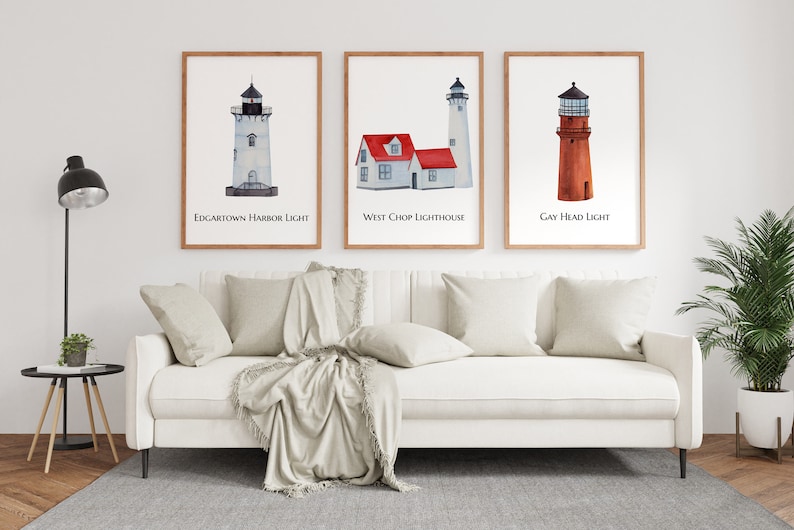 May include: Three watercolor paintings of lighthouses in wooden frames. The first painting is of Edgartown Harbor Light, the second is of West Chop Lighthouse, and the third is of Gay Head Light.