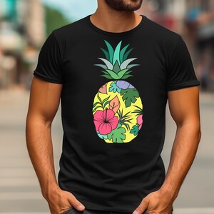 May include: A black t-shirt featuring a colourful pineapple design. The pineapple is filled with tropical flowers and leaves.