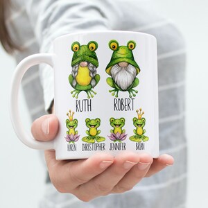 May include: White ceramic mug with a green frog gnome design. The mug has the names "Ruth", "Robert", "Karen", "Christopher", "Jennifer", and "Brian" printed on it.