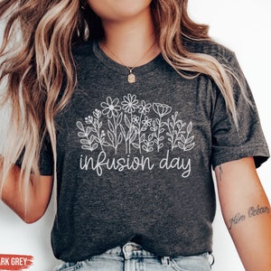 May include: Heather dark grey t-shirt with a white floral design and the text "infusion day".