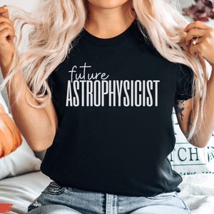 May include: A black t-shirt with the text "future astrophysicist" in white lettering.